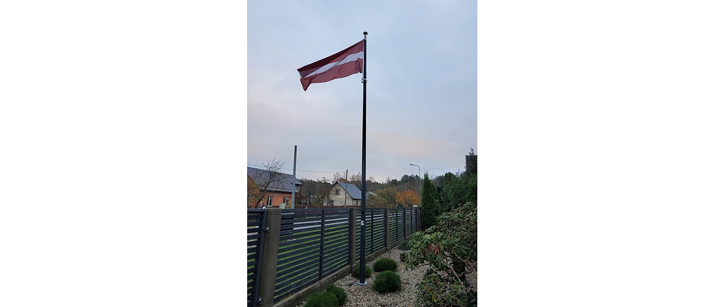 Latvian flag in the yard of a private house