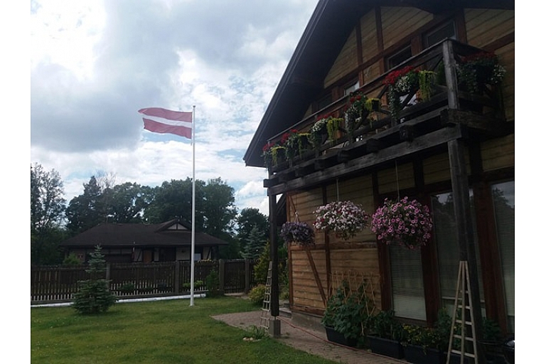 Latvian flag in the yard of a private house