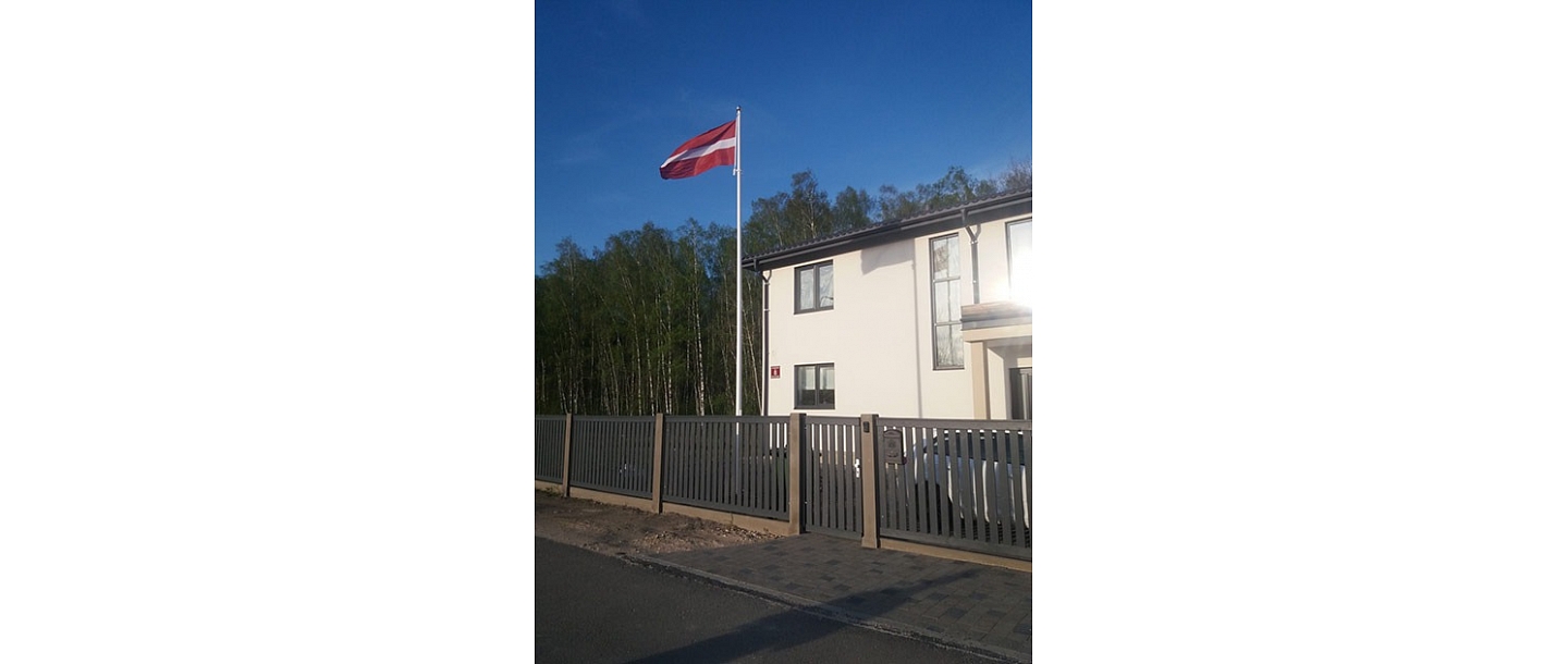 Latvian flag in the yard of a private house
