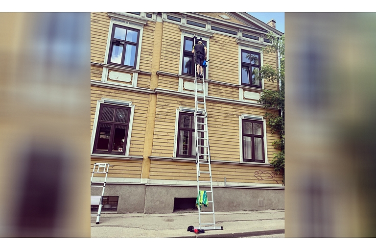 washing windows with a ladder