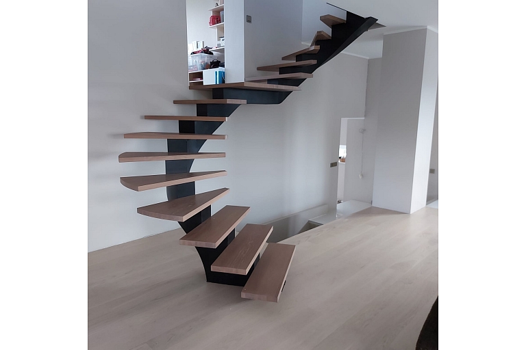 Curved metal staircase project with glass railings