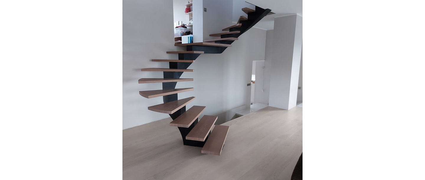 Curved metal staircase project with glass railings