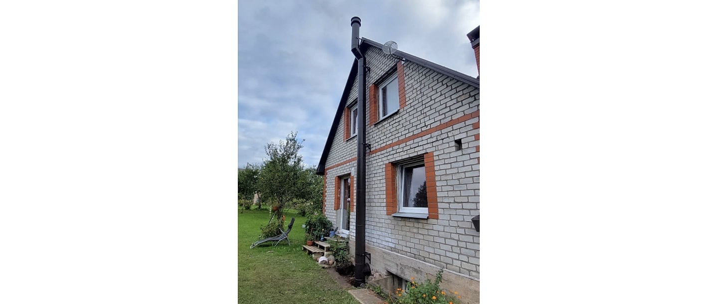 Stainless steel chimney on the roof – professional chimney installation for a private house.