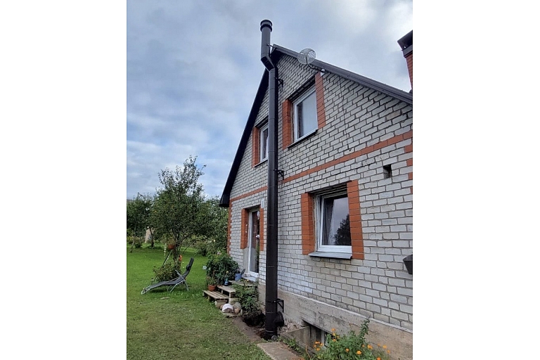 Stainless steel chimney on the roof – professional chimney installation for a private house.