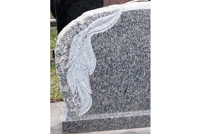 Granite monument with decorative leaf engraving