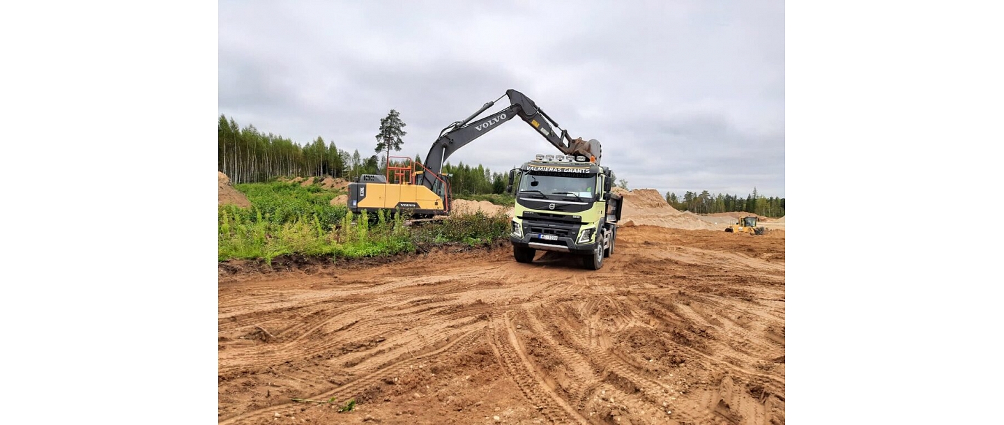 place of harvest, where a Volvo truck delivers the extracted materials for road construction